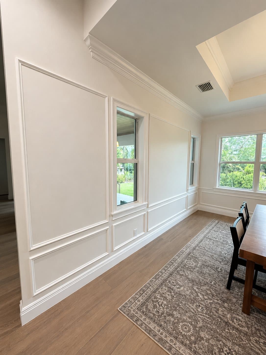 Custom wainscoting and crown molding in a dining room