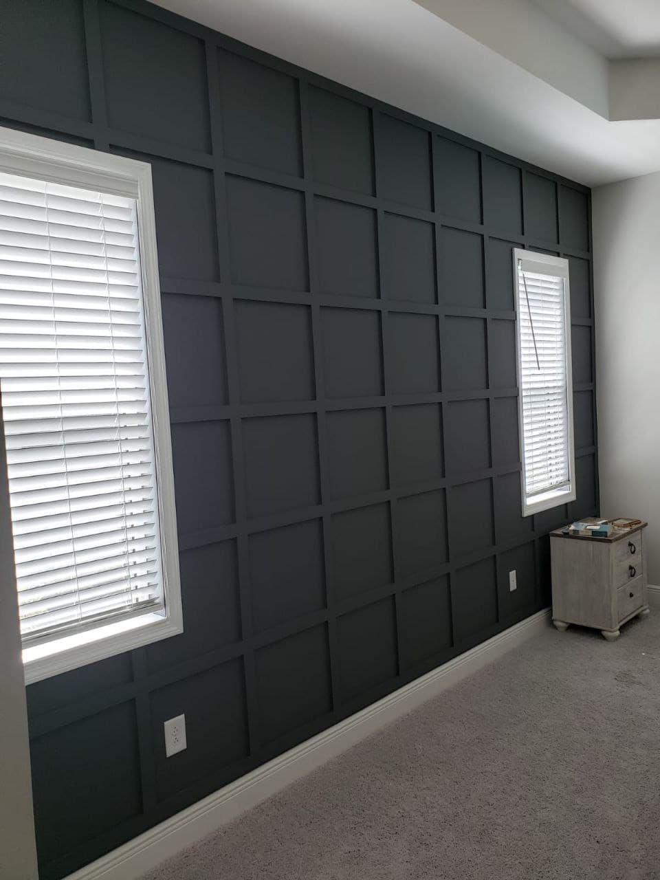 Dark square-panel accent wall in a bedroom