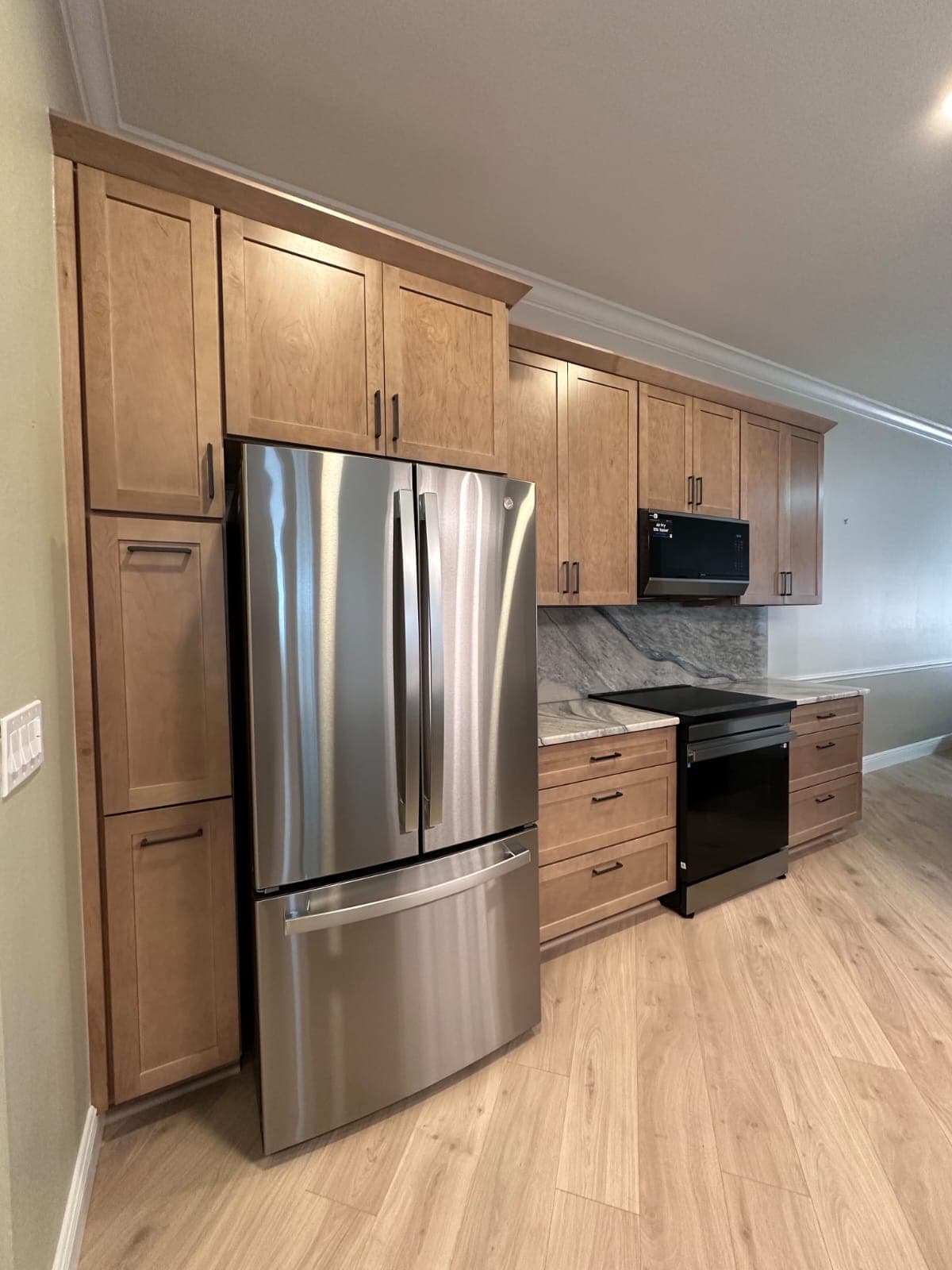Custom wood kitchen cabinetry with built-in pantry