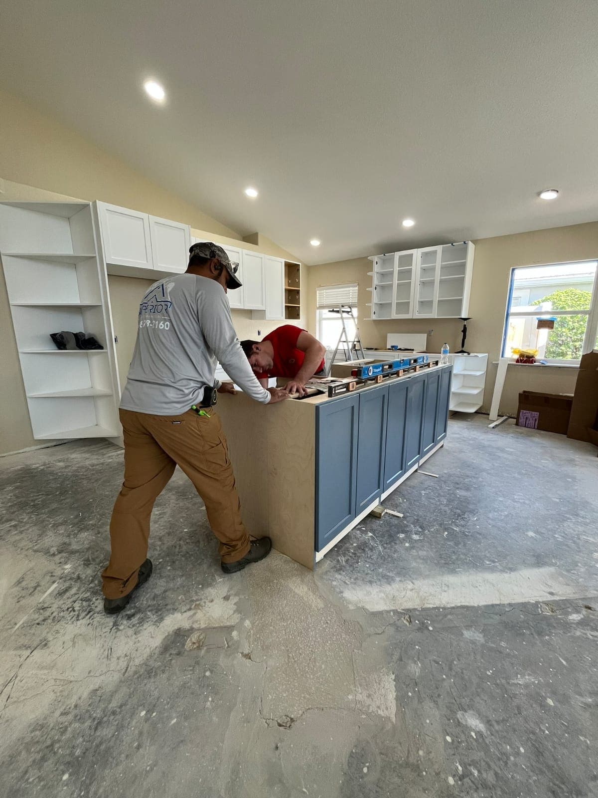 Superior Renovation team installing a kitchen island and cabinets